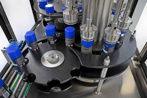 Encapsuladora rotativa - R and R Aerosol Systems - enteramente automática / de latas / para la industria química