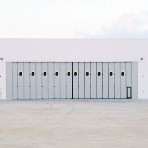 Puerta plegable - KOPRON SPA - industrial / para exteriores / de hangar