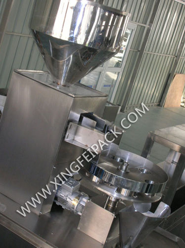 Dosificador de granulado - Shanghai Xingfei Packaging Machinery Co., Ltd. - volumétrico / automático / con plataforma giratoria