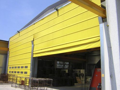 Puerta plegable - B.M.P. srl - de acero / de tejido / de PVC